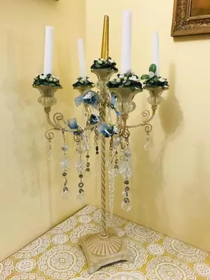 a candle holder with three candles on a wall at B&B Seneca in Rome