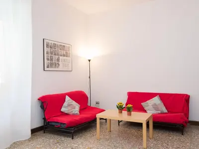 a living room with two red couches and a table at Apartment Aurelia by Interhome in Rome