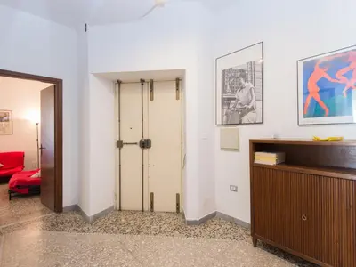 a living room with a door and a red couch at Apartment Aurelia by Interhome in Rome