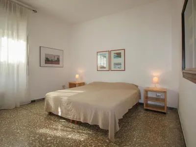 a bedroom with a bed and two tables with lamps at Apartment Aurelia by Interhome in Rome