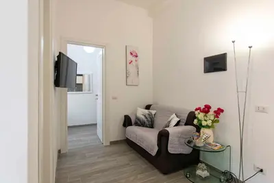 a living room with a couch and a tv at La Casa di Emanuela in Rome