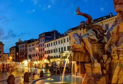 a statue of a man sitting on an elephant next to a fountain at Navona Stay in Rome