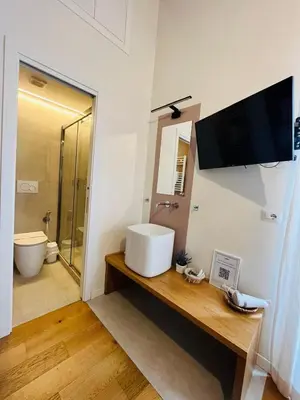a bathroom with a sink and a toilet at Torre Tolomei Trastevere in Rome