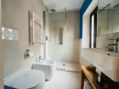 a bathroom with a white toilet and a sink at Torre Tolomei Trastevere in Rome