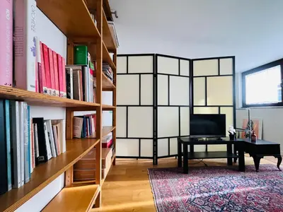 a room with a desk and bookshelves at Torre Tolomei Trastevere in Rome