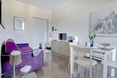 a living room with a purple couch and a table at Colosseo Gardens - My Extra Home in Rome