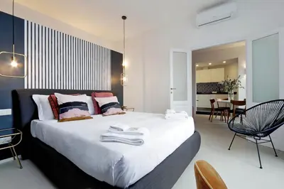 a bedroom with a large bed with towels on it at YCH-Bright Penthouse near COLOSSEUM in Rome