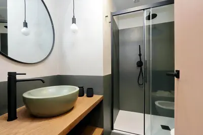a bathroom with a bowl sink and a shower at YCH-Bright Penthouse near COLOSSEUM in Rome