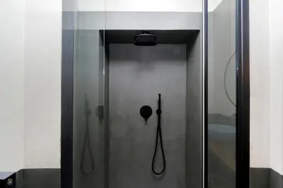 a shower with a glass door in a bathroom at YCH-Bright Penthouse near COLOSSEUM in Rome