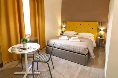 a bedroom with a bed and a table and chairs at BorgoNove in Rome