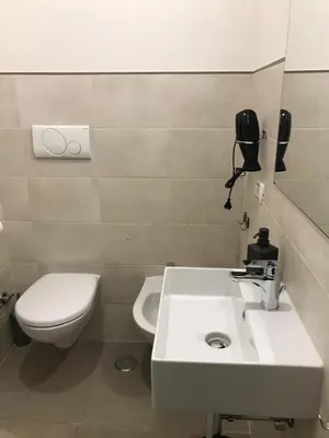 a bathroom with a white sink and a toilet at BorgoNove in Rome