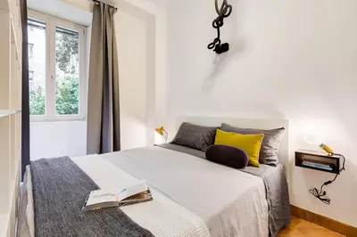 a bedroom with a bed with a book on it at Vasari's Home in Rome