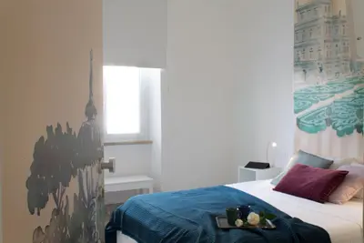 a bedroom with a bed with a tray of food on it at Angolo sul Giardino in Rome