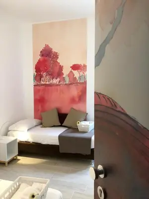a room with a bed and a painting on the wall at Angolo sul Giardino in Rome