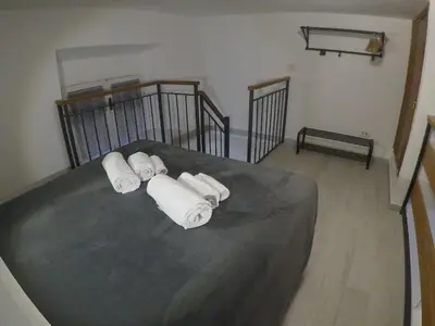 a bedroom with a bed with three rolls of towels at Your home near to the Vatican in Rome