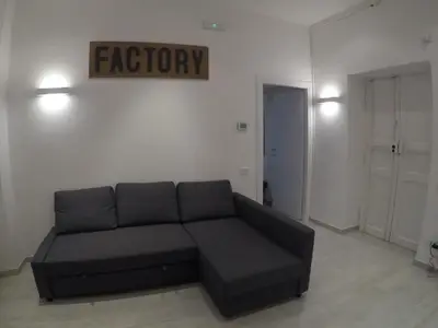 a living room with a couch and a sign that reads factory at Your home near to the Vatican in Rome