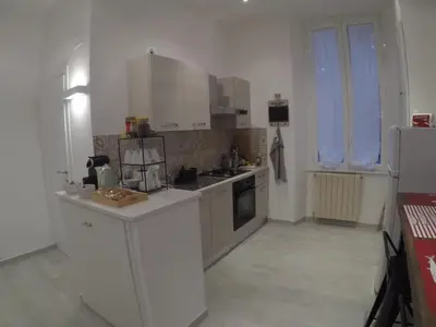 a small kitchen with white cabinets and a sink at Your home near to the Vatican in Rome