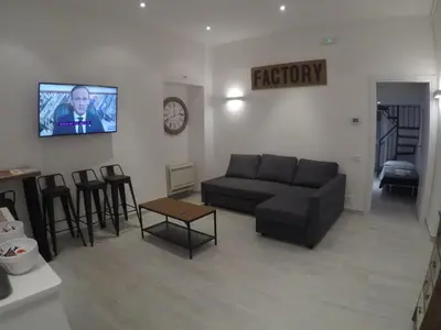 a living room with a couch and a flat screen tv at Your home near to the Vatican in Rome