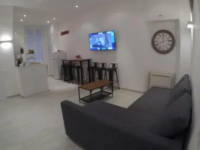a living room with a couch and a clock on the wall at Your home near to the Vatican in Rome