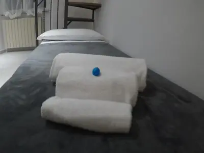 a bed with towels and a blue ball on it at Your home near to the Vatican in Rome