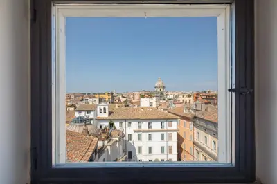 a view of a city from a window at Farnese Stunning Penthouse | Romeloft in Rome