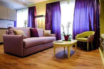 a living room with a purple couch and a table at San Pietro Rhome in Rome