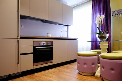 a kitchen with a refrigerator and two stools at San Pietro Rhome in Rome
