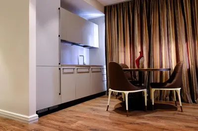 a kitchen with a table and chairs in a room at San Pietro Rhome in Rome
