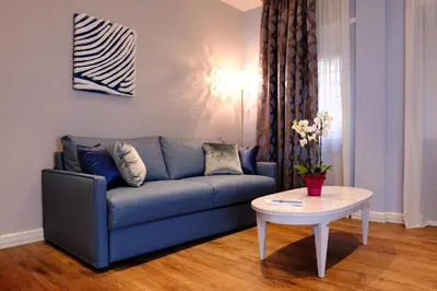 a living room with a blue couch and a table at San Pietro Rhome in Rome
