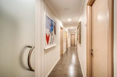 a corridor of a hallway with paintings on the walls at Boutique Rome Inn in Rome