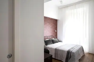 a bedroom with a bed and a large window at Four Elements in Rome