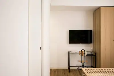 a bedroom with a bed and a television on a wall at Four Elements in Rome