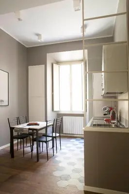 a kitchen and dining room with a table and chairs at Four Elements in Rome