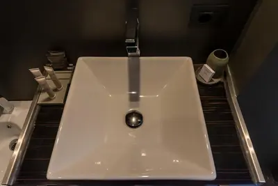 a white sink in a bathroom with a toilet at Campo Marzio Luxury Suites in Rome