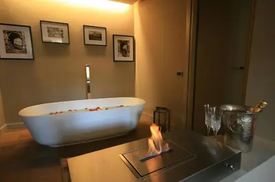 a bath tub sitting on a table in a bathroom at Campo Marzio Luxury Suites in Rome