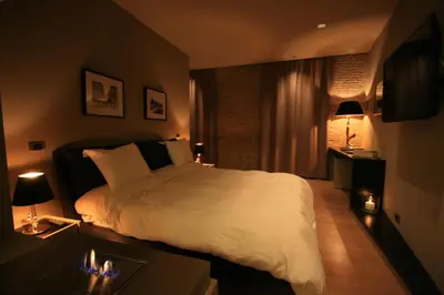 a bedroom with a large white bed and a window at Campo Marzio Luxury Suites in Rome