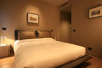 a bedroom with a large white bed in it at Campo Marzio Luxury Suites in Rome