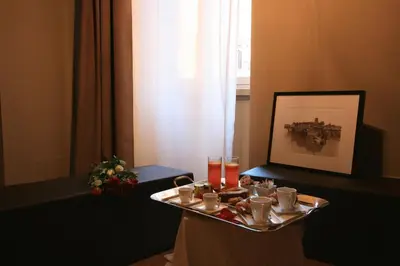 a tray with cups and drinks on a table at Campo Marzio Luxury Suites in Rome