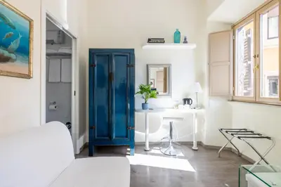 a room with a blue door and a white table at Temple View FCollection Superior Relais in Rome