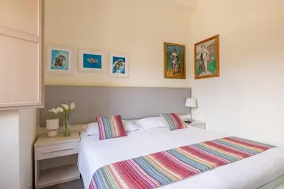 a bedroom with a white bed and pictures on the wall at Temple View FCollection Superior Relais in Rome