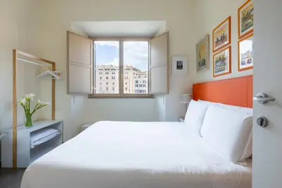 a bedroom with a white bed and a window at Temple View FCollection Superior Relais in Rome