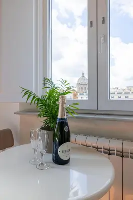 a bottle of wine sitting on a table with two glasses at Temple View FCollection Superior Relais in Rome