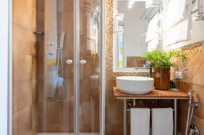 a bathroom with a shower and a sink at Temple View FCollection Superior Relais in Rome