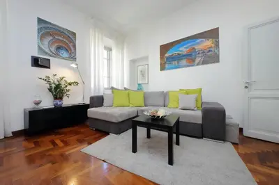 a living room with a couch and a table at LUXURY APARTMENT VATICANO-S'PETER BASILICA - NETFLIX Wifi - AirCond in Rome