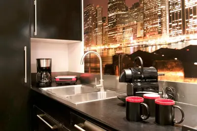 a kitchen counter with a sink and red cups at LUXURY APARTMENT VATICANO-S'PETER BASILICA - NETFLIX Wifi - AirCond in Rome