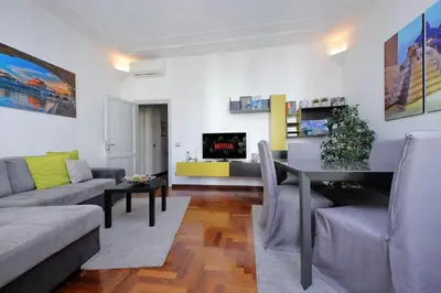 a living room with a couch and a table at LUXURY APARTMENT VATICANO-S'PETER BASILICA - NETFLIX Wifi - AirCond in Rome