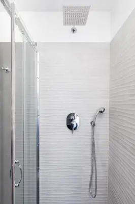 a shower with a shower head in a bathroom at A World Aparts - 32 Modena in Rome