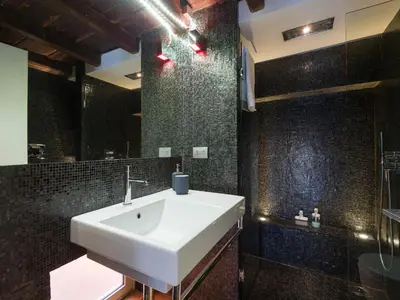 a bathroom with a white sink and a shower at Loft in Trastevere in Rome