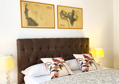 a bedroom with a bed with two pictures on the wall at Trastevere Boulevard in Rome