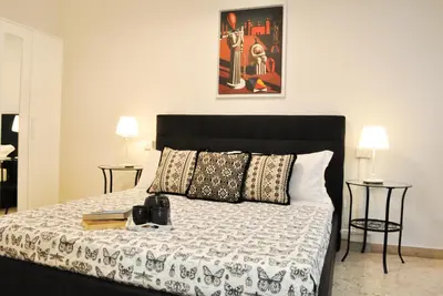 a bedroom with a bed with a camera on it at Trastevere Boulevard in Rome